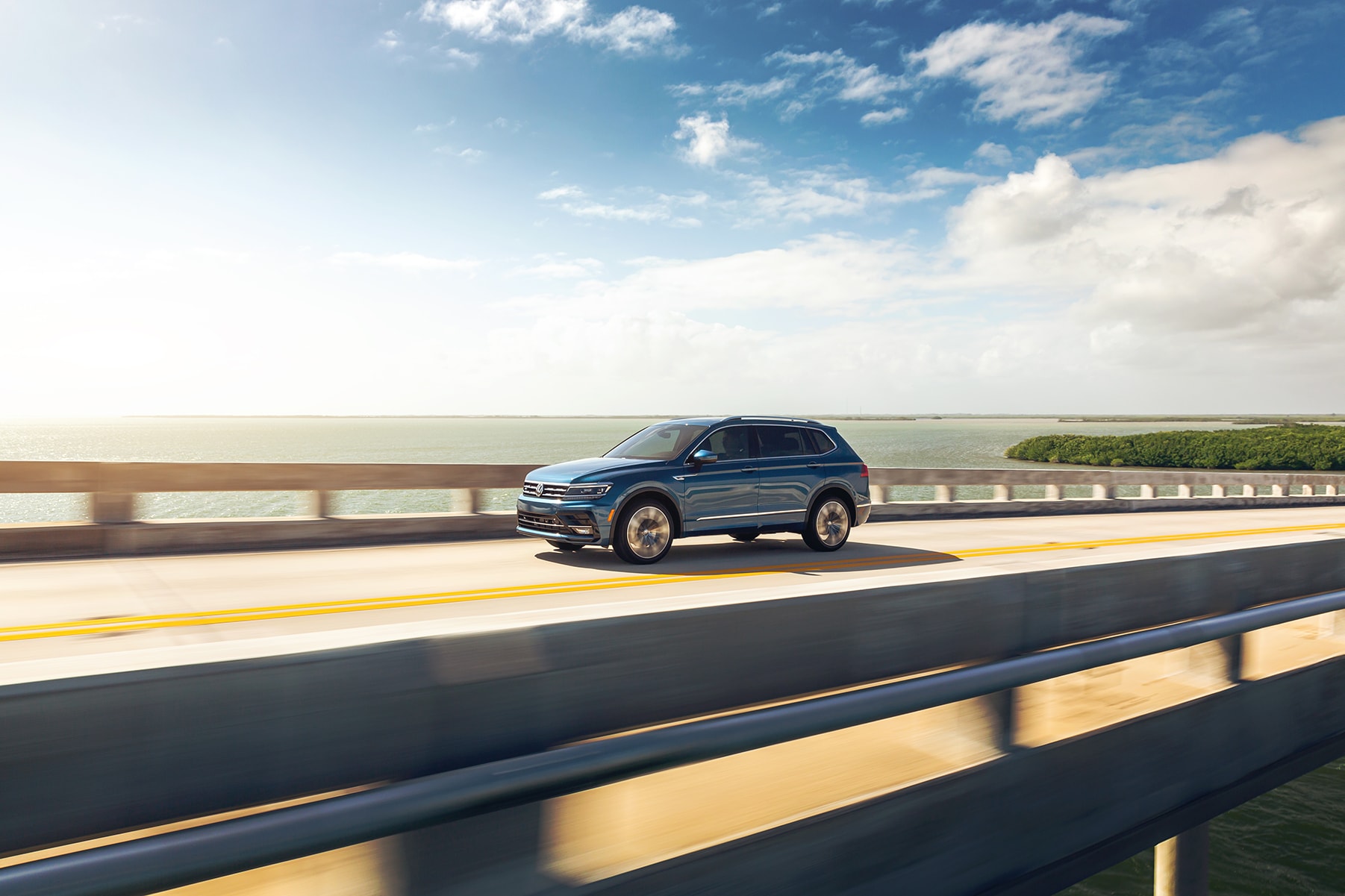 West Broad Volkswagen is a Volkswagen Dealership in Richmond near Ashland, VA | 2021 Volkswagen Tiguan driving on bridge