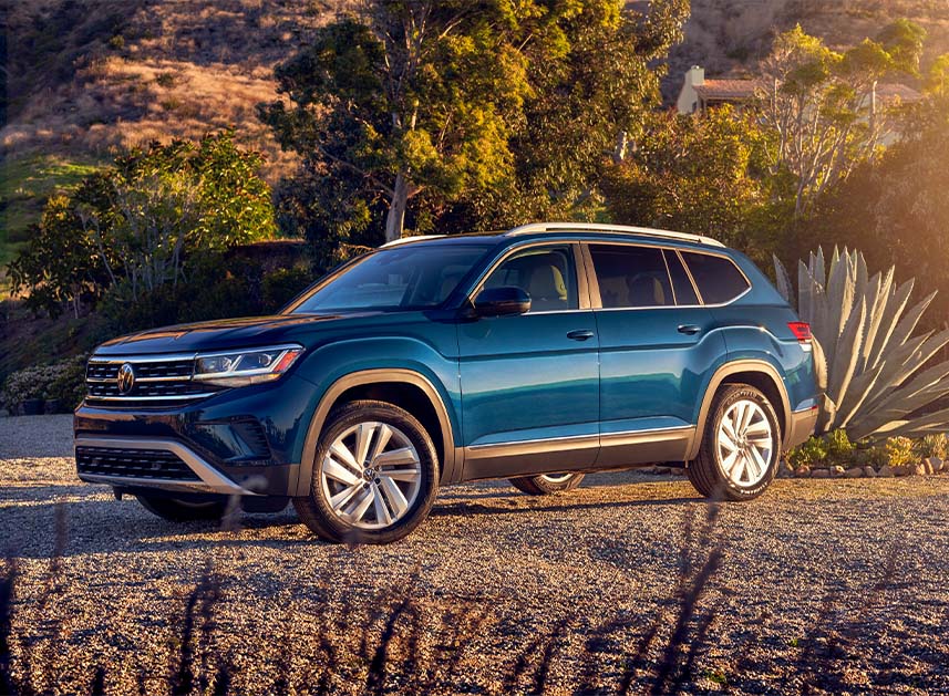 Compare the 2021 Volkswagen Atlas vs. the 2021 Ford Escape at West Broad Volkswagen | Blue 2021 Volkswagen Atlas Parked in Desert at Sunset