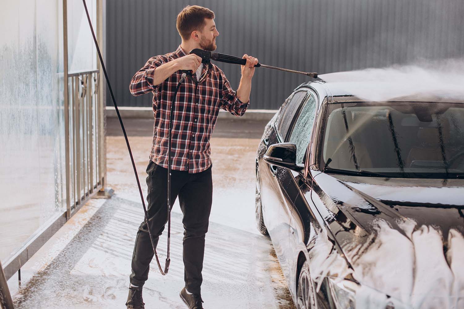 Tips for spring cleaning your car at West Broad Volkswagen in Richmond, VA | Man washing his car at the beginning of spring