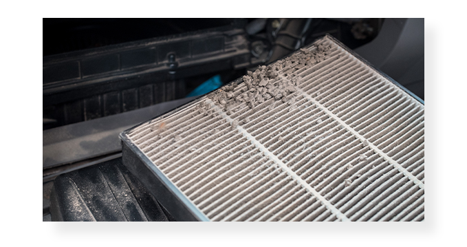 Everything You Need to Know About Cabin Air Filters | West Broad VW | Close up of a dirty cabin filter being taken out 