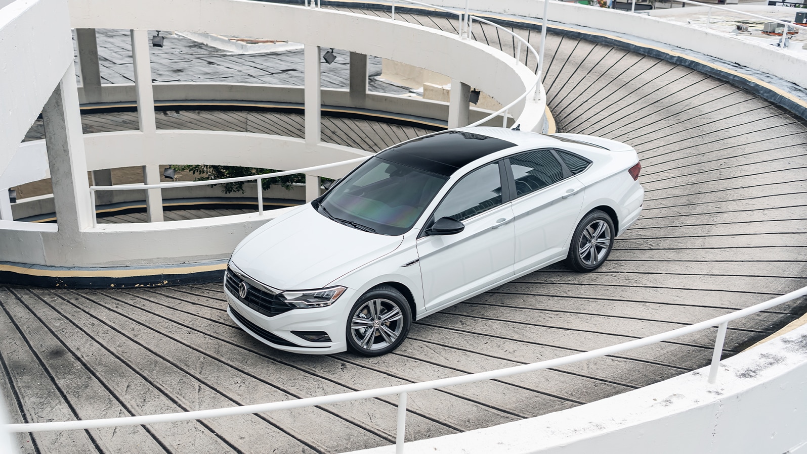 3 Main Benefits of Using OEM parts for your vehicle at West Broad VW in Richmond, VA | White 2023 Volkswagen Passat driving down a parking garage 