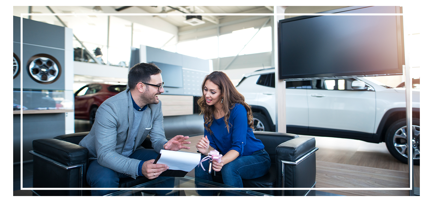 Things to Bring with you to Purchase a Car at West Broad Volkswagen in Richmond, VA | Sales person talking to customer about car documents 