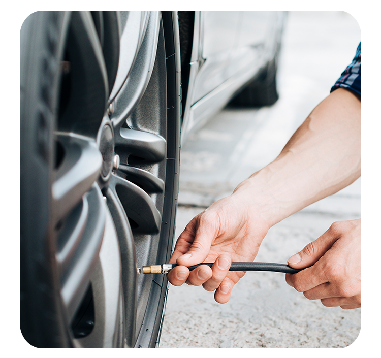 Tire Pressure Information at West Broad VW in Richmond, VA | Man about to attach tire pressure hose into his tire valve 
