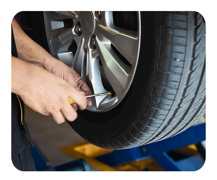 Tire Pressure Information at West Broad VW in Richmond, VA | Mechanic removing the tire pressure valve of a tire