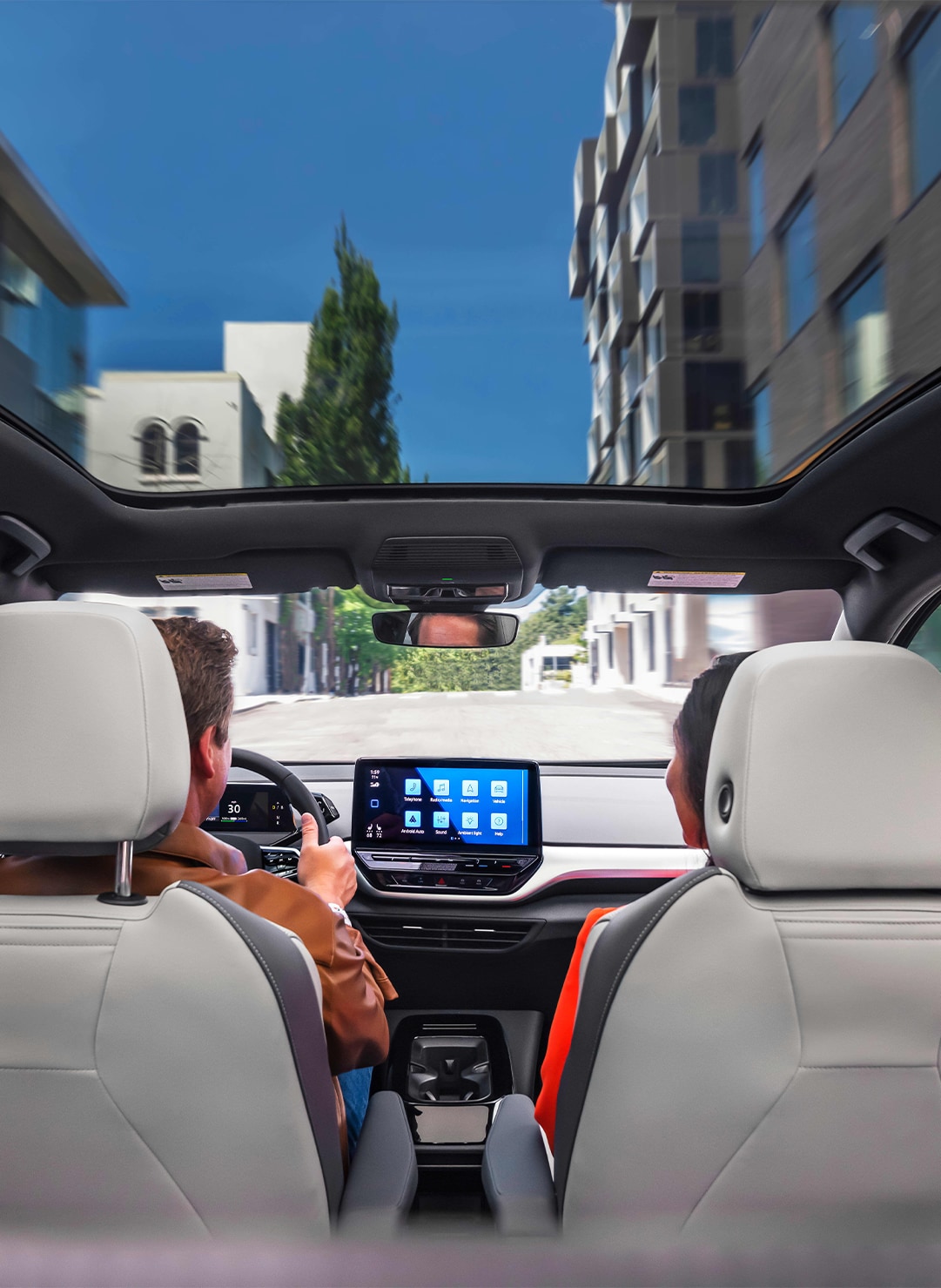 2023 ID.4 Electric SUV at West Broad VW | Interior of a 2023 Volkswagen ID.4 with sunroof and couple driving the car 