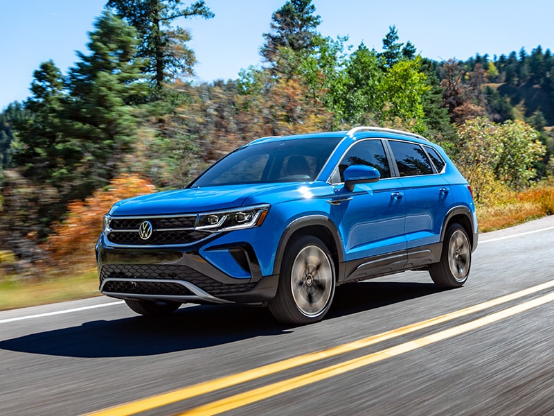 What Different Tire Options are Available at West Broad Volkswagen in Richmond | 2022 Volkswagen Taos Driving on Road Past Trees