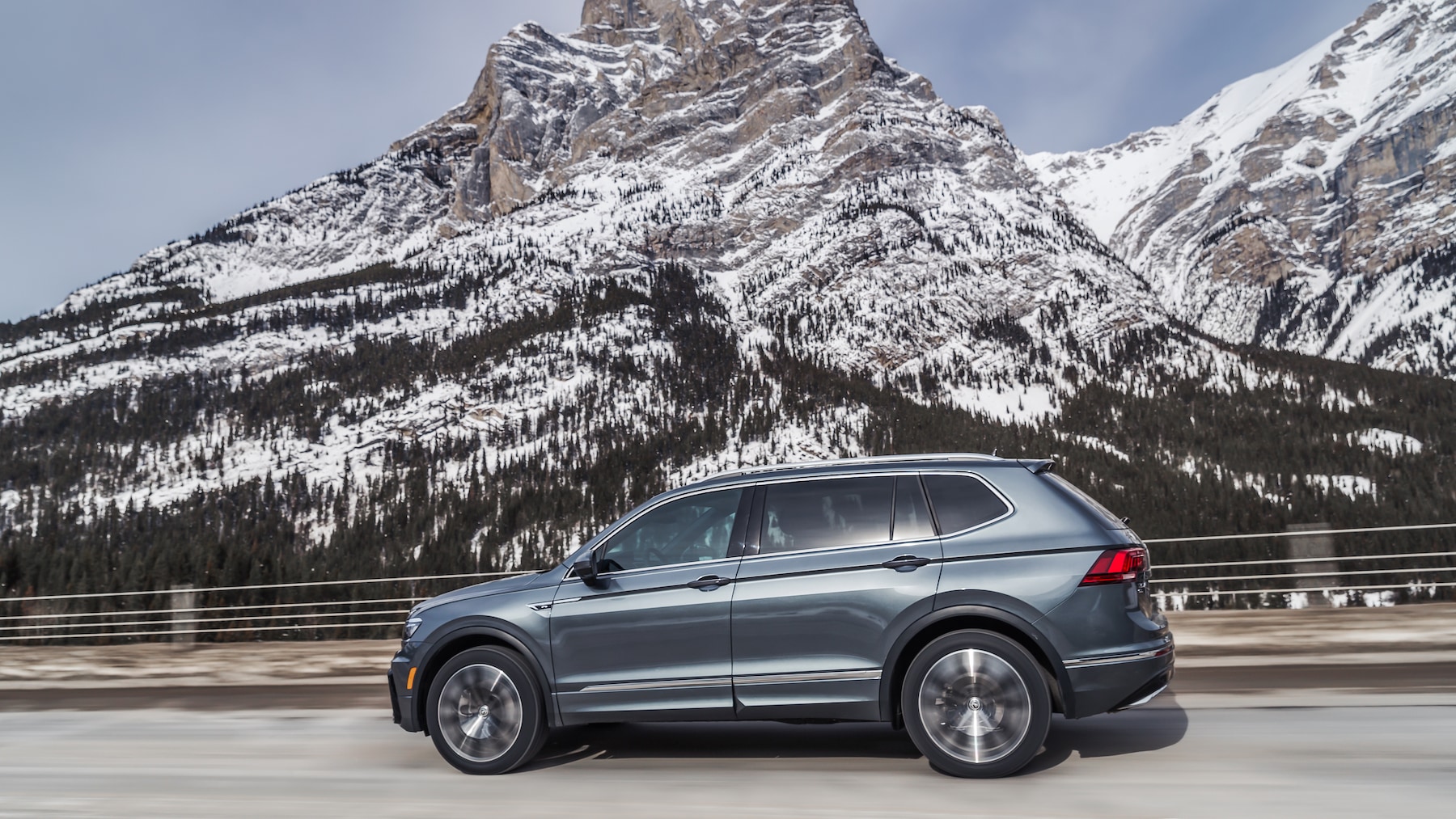 West Broad Volkswagen is a Volkswagen Dealership near Innsbrook, VA | 2020 Volkswagen Tiguan driving past snowy mountain