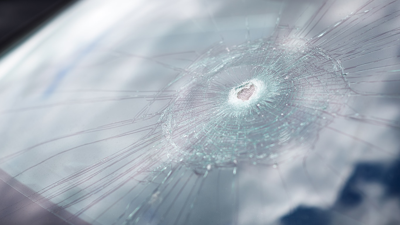 Why You Shouldn’t Drive Around with a Chipped Windshield at West Broad VW in Richmond, VA | Hole in car windshield with a reflection of the sky