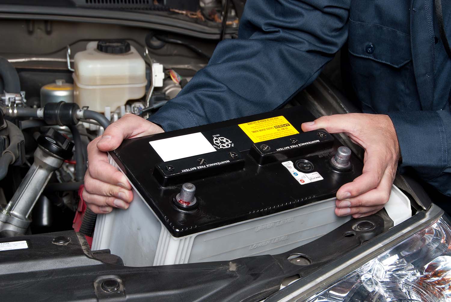 Everything You Need to Know about Your Car Battery at West Broad Volkswagen | Volkswagen service technician replacing battery in vehicle