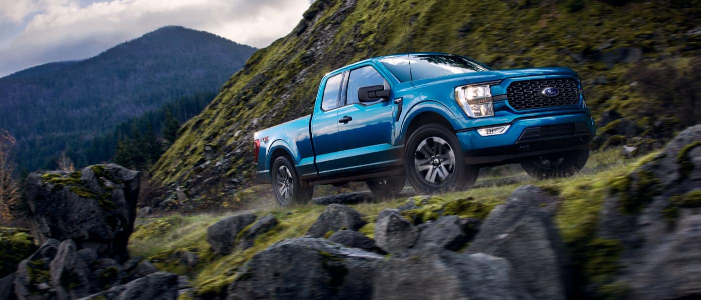 2021 Blue Ford F-150 Driving up a Mountain