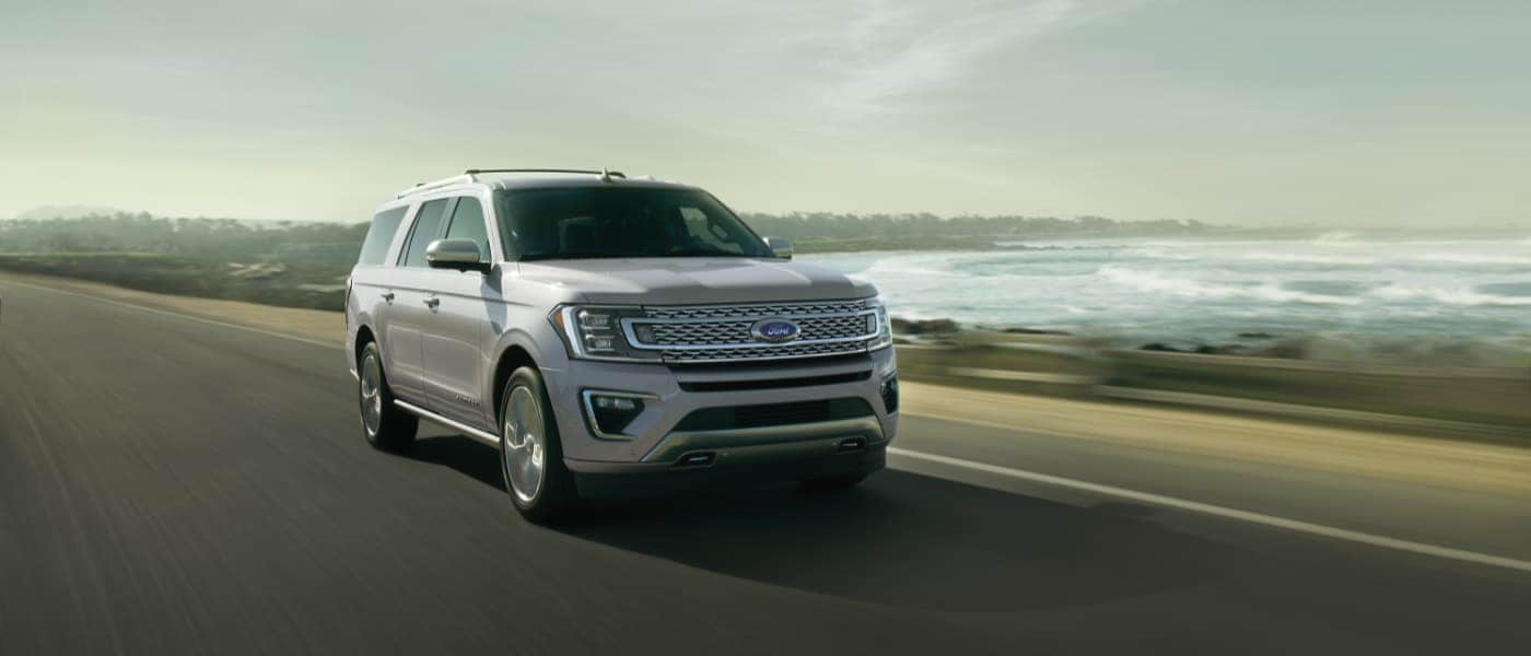 2020 White Ford Expedition Driving by the Ocean
