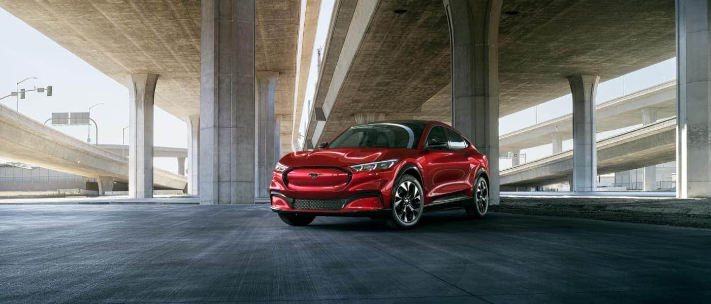 2021 Red Ford Mustang Mach-E Parked Under a Bridge