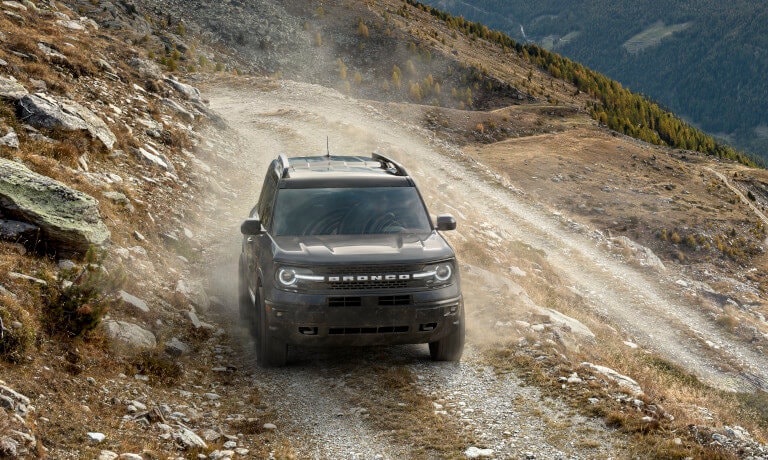 2023 Ford Bronco driving head on by the side of a mountain