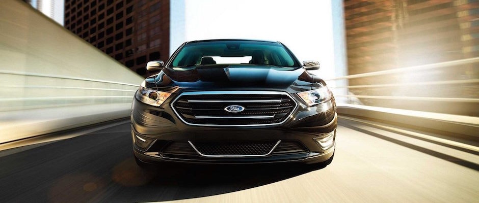 2018 Ford Taurus Model Differences in Countryside, IL A black 2018 Ford Taurus driving down the highway