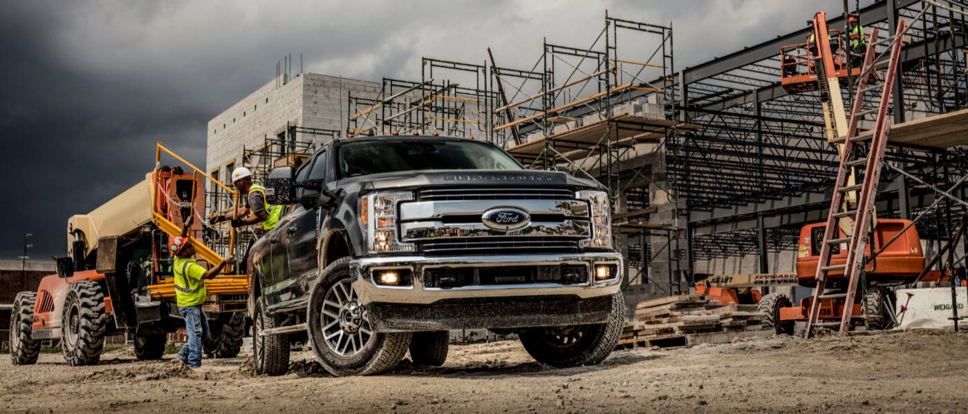 2019 Black Ford F-350 Loading Construction Equipment