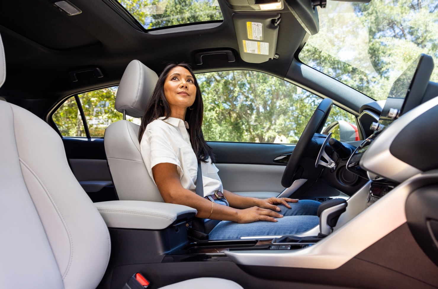 woman enjoys the sunroof in the 2023 Mitsubishi Eclipse