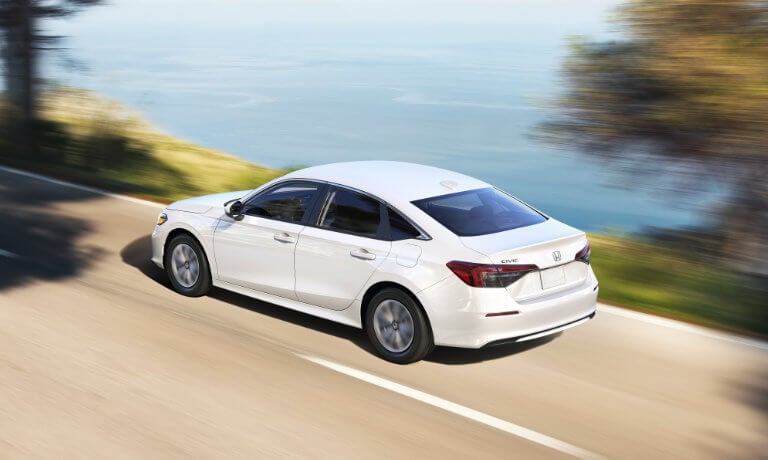 2025 Honda Civic driving by the ocean