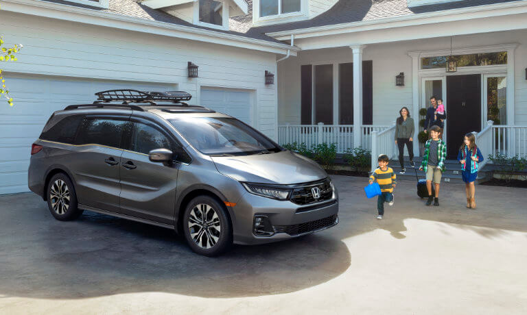 2025 Honda Odyssey parked in driveway with family