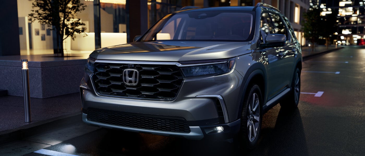 2025 Honda Pilot parked on a city street at night