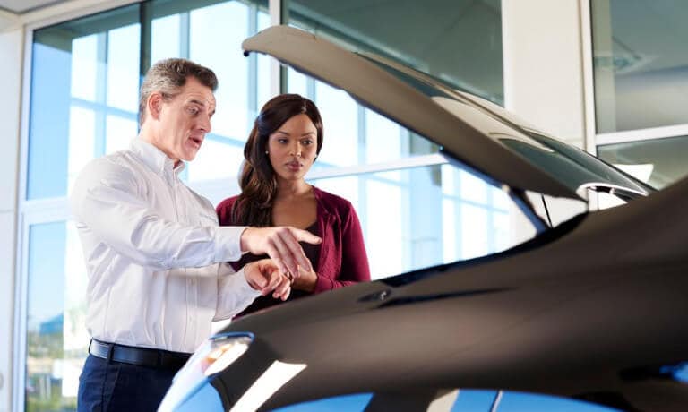 Honda Dealership employee and Customer checking under car hood