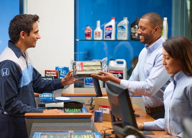 Honda technician handing over parts