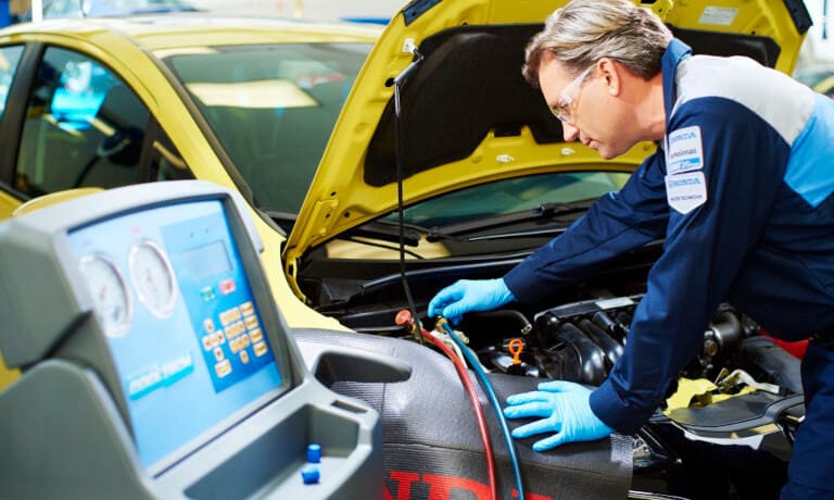 Honda technician checking under hood