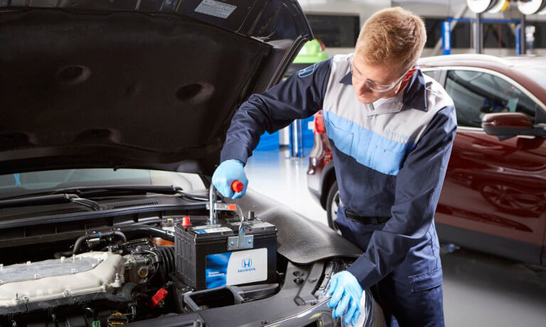 Honda technician replacing battery
