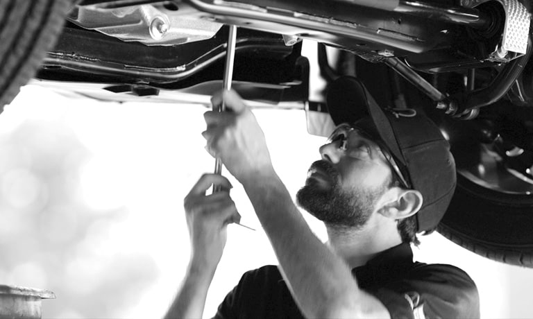 Service Tech Working Under Car