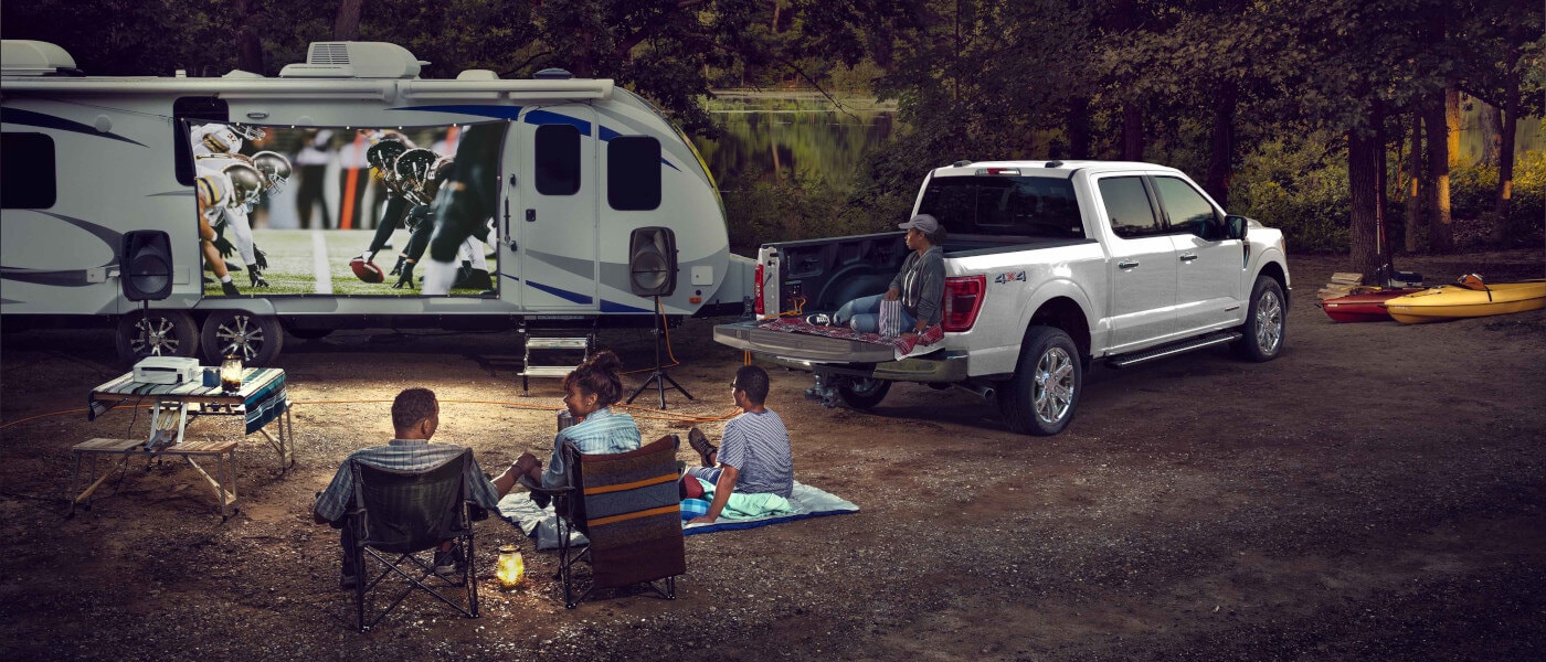 2026 Ford F-150 parked with RV and family watching football