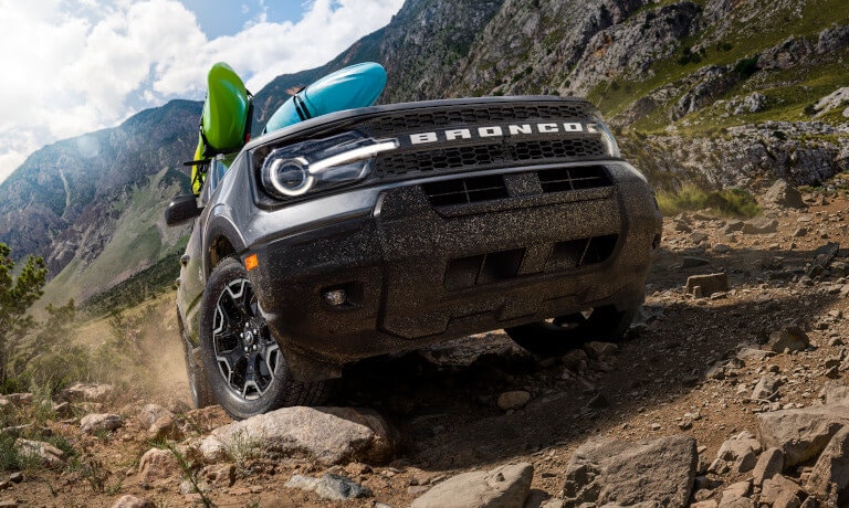 2026 Ford Bronco Sport driving on muddy trail with kayaks