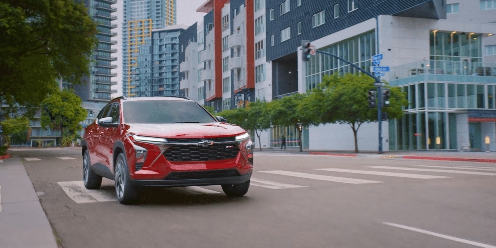 A 2026 Chevrolet Trax driving on a city road, showcasing its nimbleness.