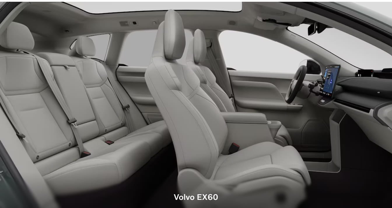 Volvo EX60 interior with light-colored seating, a panoramic roof, and a center touchscreen display.