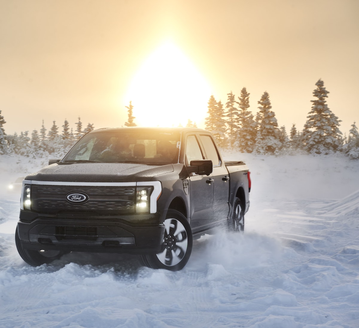 Ford F-150 driving through fresh snow, ready for winter weather