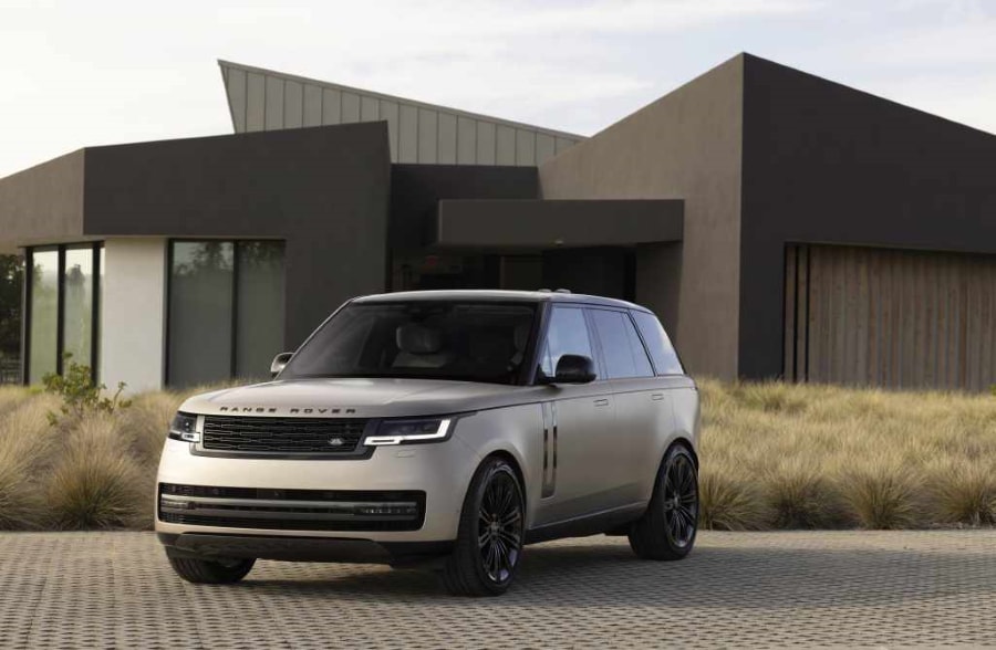 2022 Range Rover parked in front of a pointy house