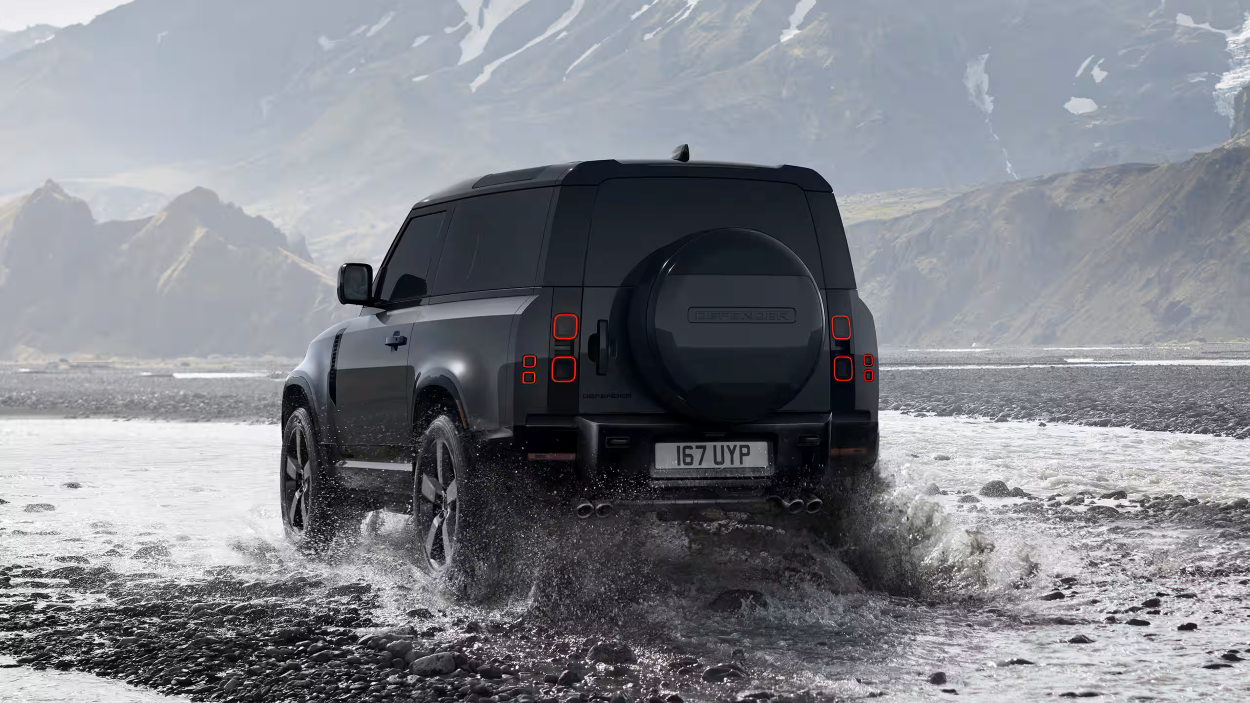 2026 defender 90 ext in action with mountains in background