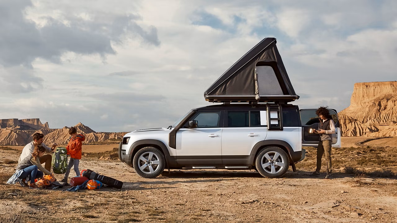 2026 Defender 130 with a family on a camping trip