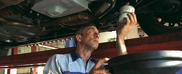 A mechanic performing an oil change