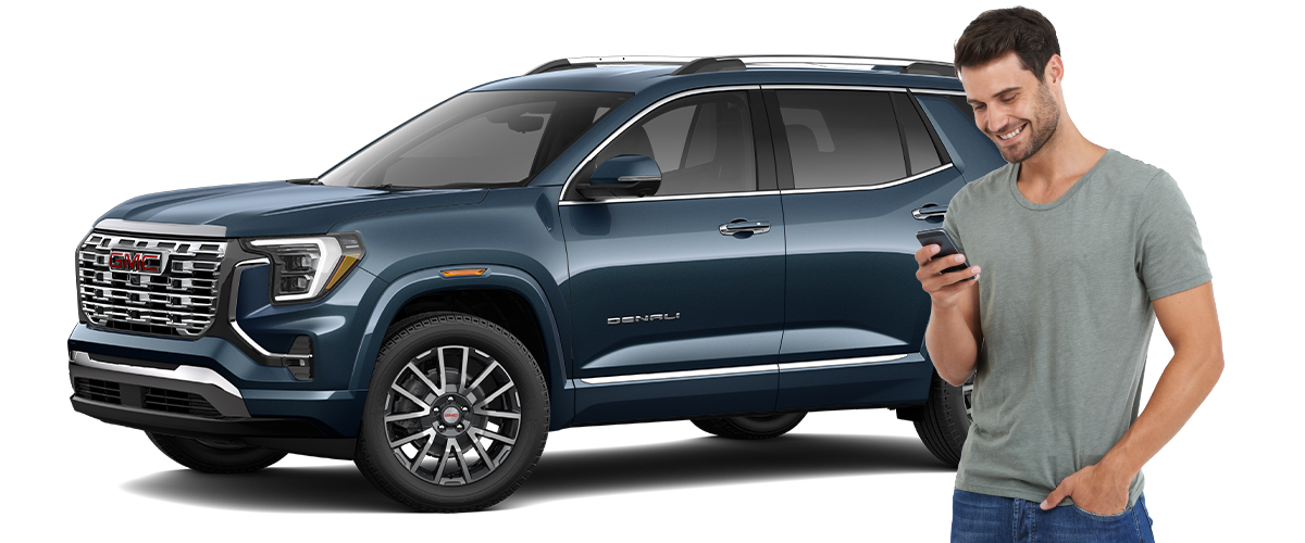 Man on the phone in front of a gmc suv