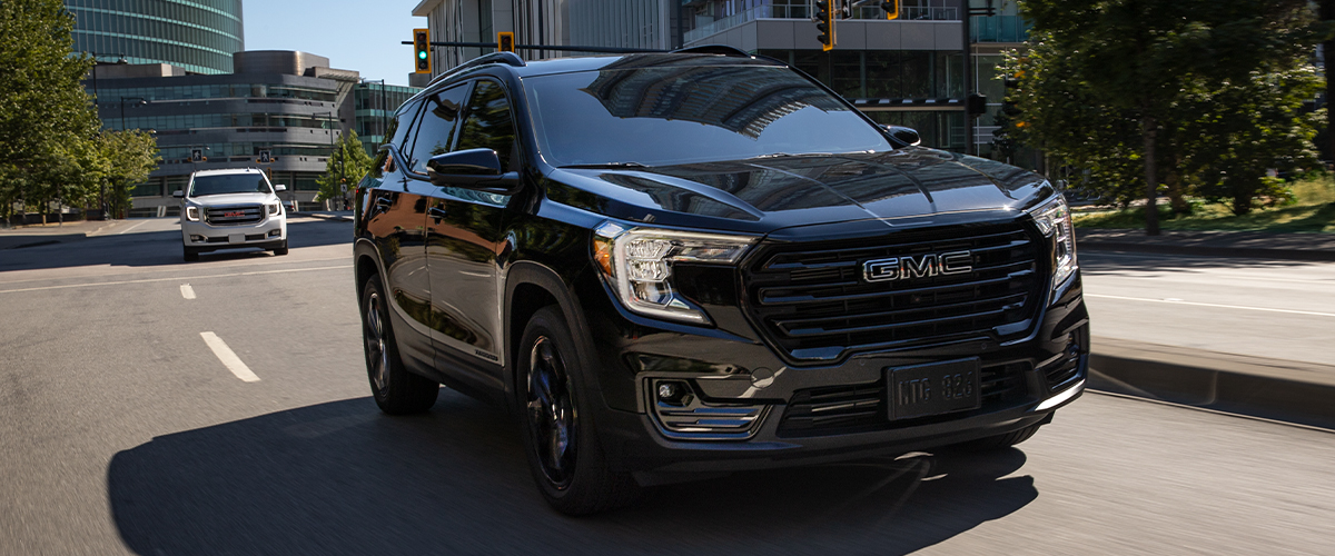 Black GMC SUV driving on the city streets