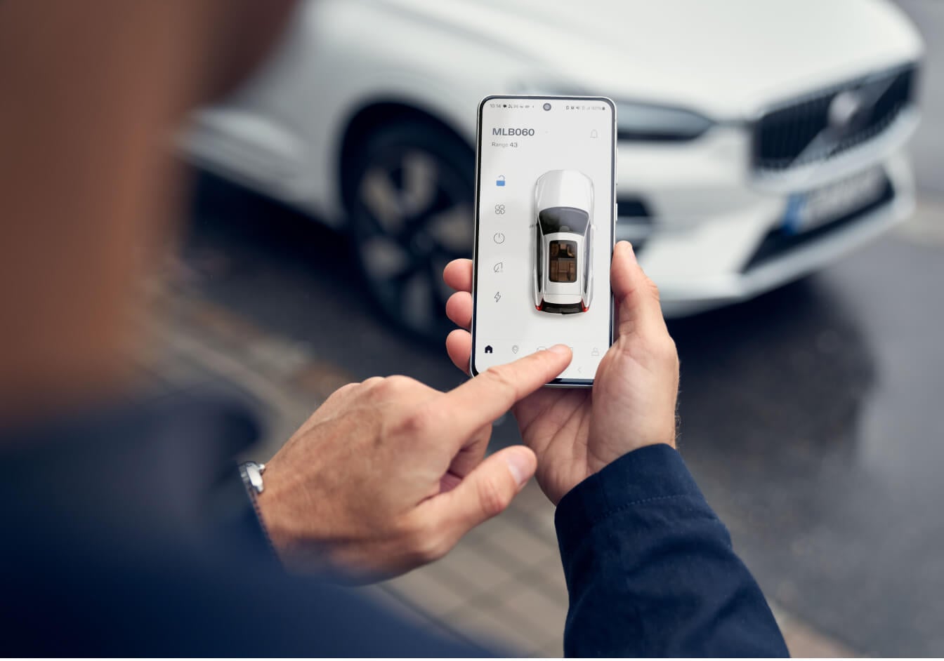 Exterior view of a Volvo XC60 in Crystal White showcasing the remote vehicle control features on the Volvo Cars mobile app