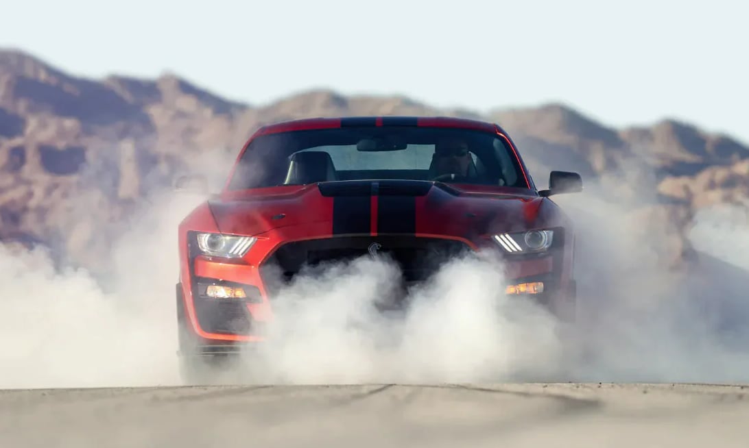 Man performing a burnout in the Ford Mustang Shelby GT500