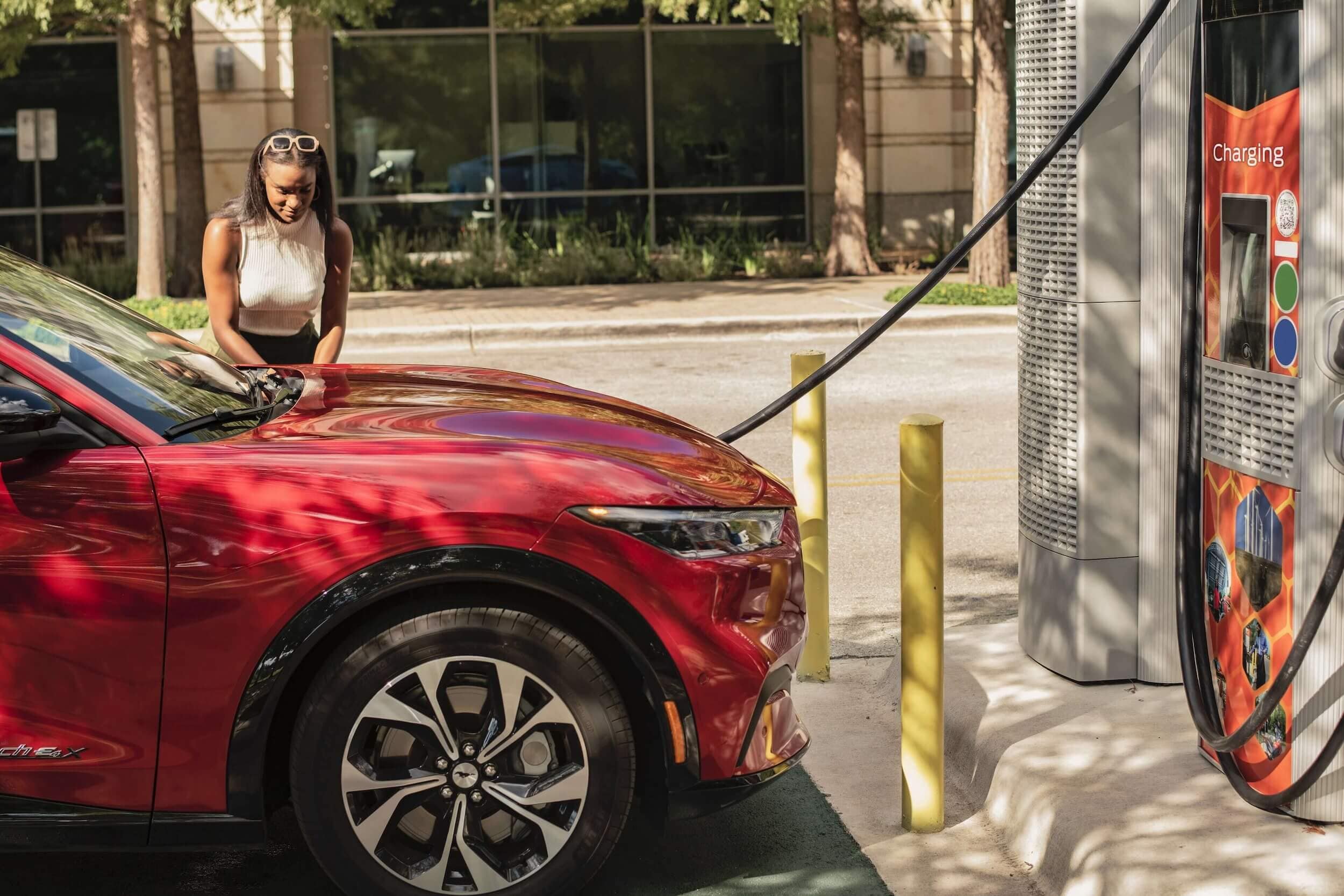 Woman plugging in Mustang Mach-E to charger