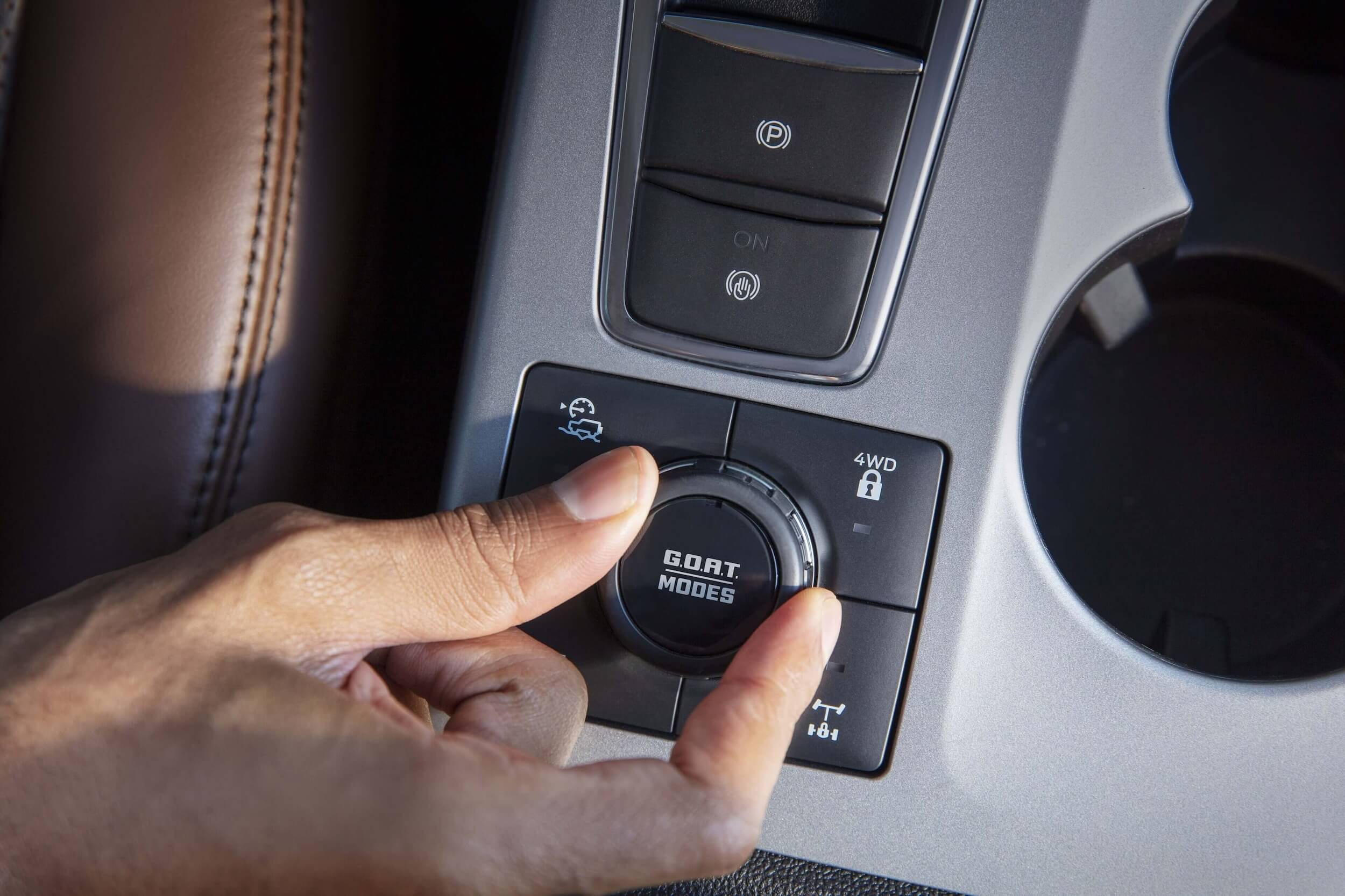 Close up of someone using sport modes in a car
