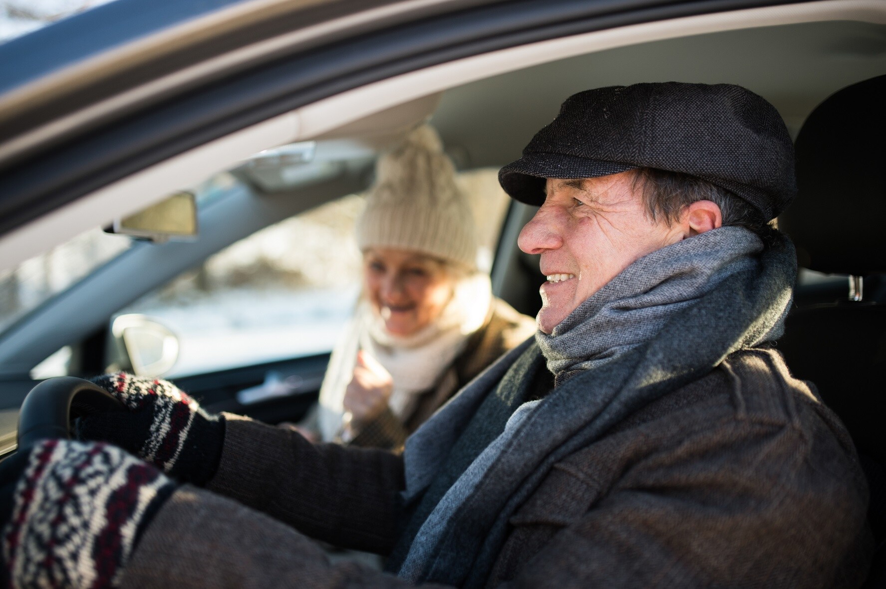 woman-and-man-in-winter-clothes-driving-a-car_S_V8OO8GW.jpg