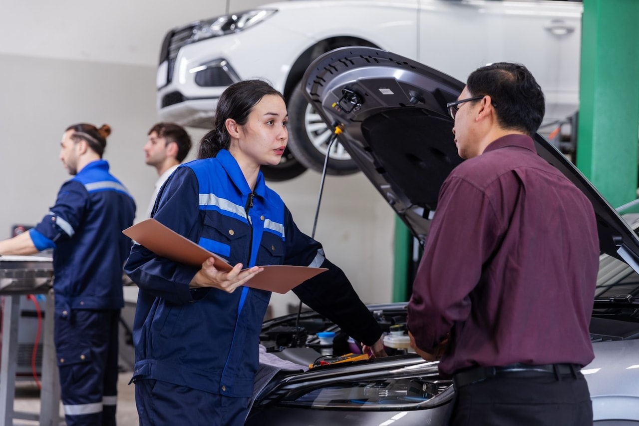 Young Ford of Ogden technician reviewing a multi-point inspection with a customer