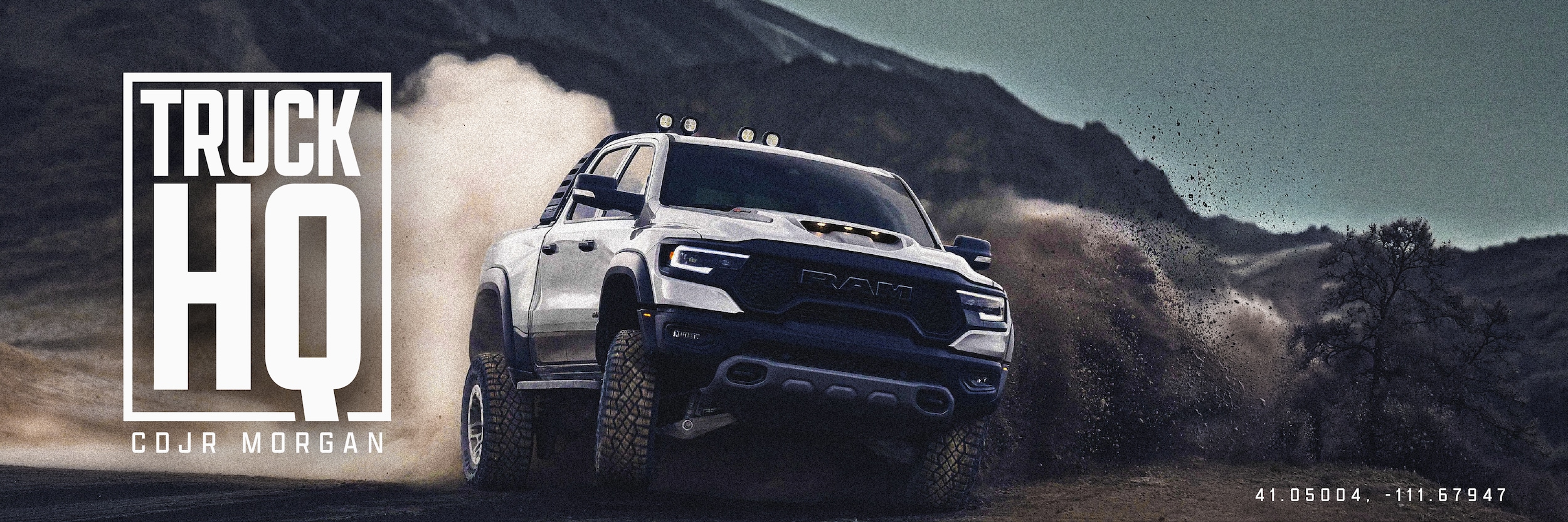 White RAM 1500 TRX kicking up dust on a mountain trail, Truck HQ at CDJR Morgan