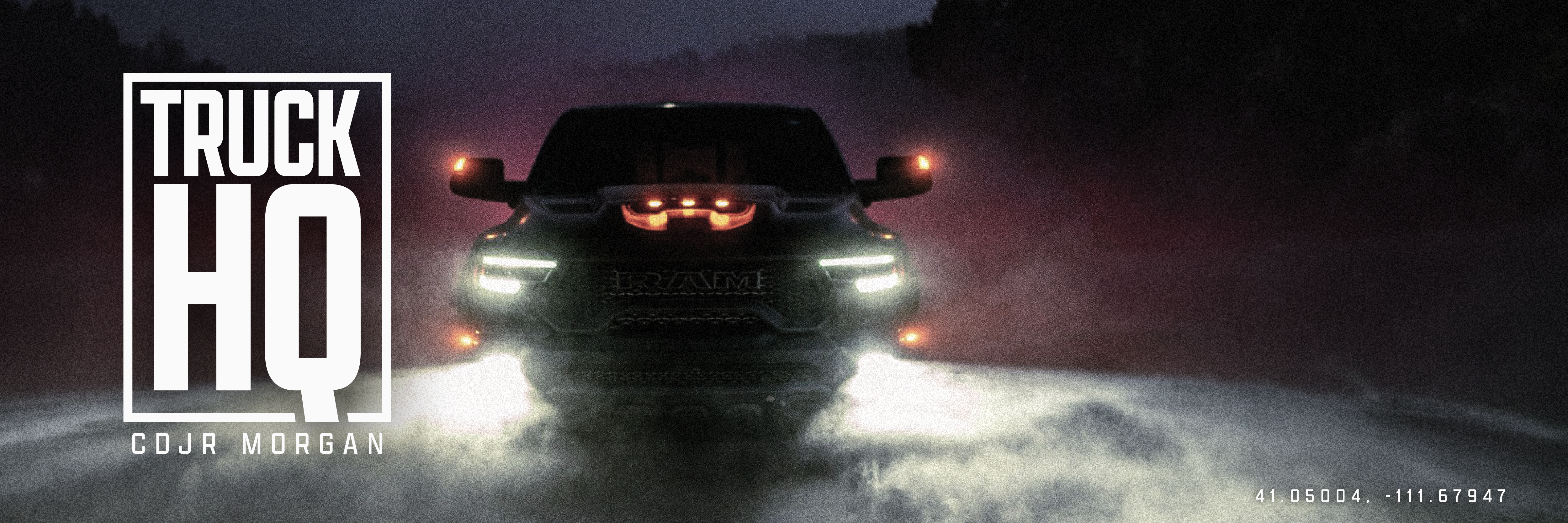 RAM truck with amber marker lights glowing through fog at dusk